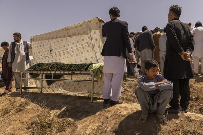 Ruhullah, 16, mourns during <a href="index.php?page=&url=https%3A%2F%2Fwww.nytimes.com%2F2021%2F08%2F27%2Fworld%2Fasia%2Fafghanistan-airport-bombing-family.html" target="_blank" target="_blank">the burial of his father,</a> Hussein, a former police officer who was killed in the suicide bombing at the airport in Kabul. Ruhullah survived the blast but did not know his father had died until he made his way back to his family the next day.
