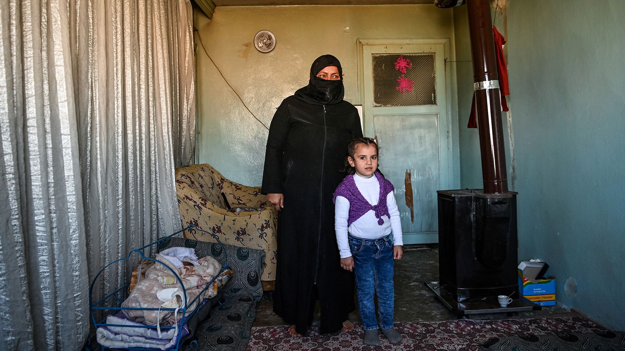 Syrian refugee Areej Beidun, 6, (R) and her grandmother Nadesa Beidun pose in Gaziantep, southeastern Turkey, on February 26, 2021. 