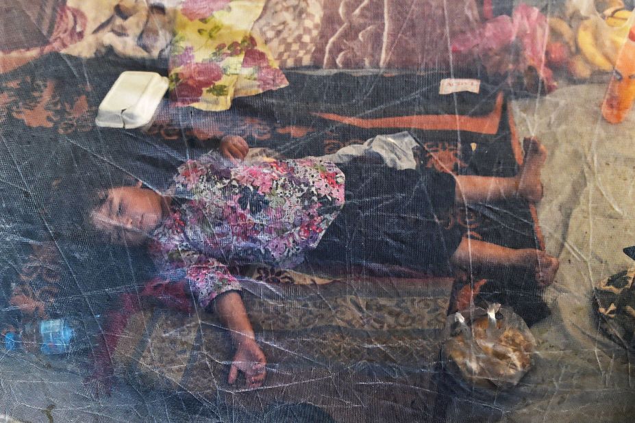 A displaced child sleeps under a mosquito net at a makeshift camp in Khyber Pakhtunkhwa on August 29.