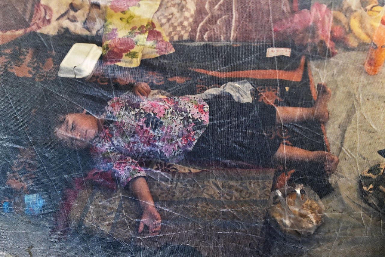 A displaced child sleeps under a mosquito net at a makeshift camp in Khyber Pakhtunkhwa on August 29.