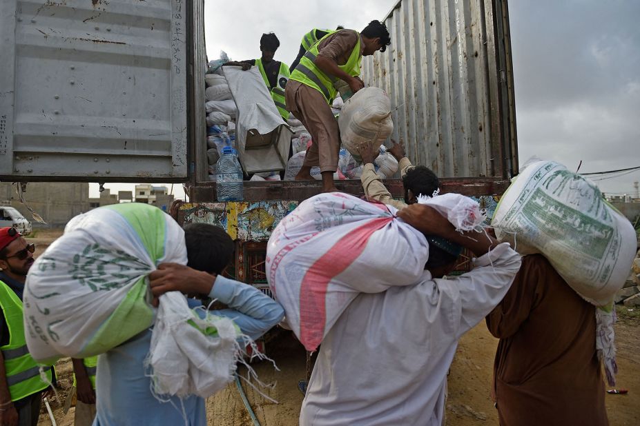 Volunteers load relief food bags on a truck in Karachi, Pakistan, on August 28.