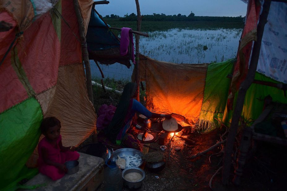 A woman cooks food for her flood-affected family at a makeshift camp in Nawabshah, Pakistan, on August 25.