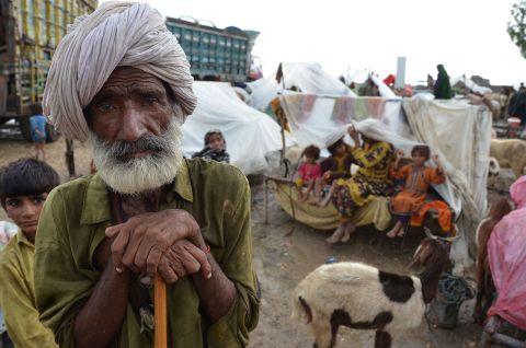 Villagers take shelter at a makeshift camp after their homes were damaged by flooding in Pakistan's Jaffarabad district on Wednesday, August 24.