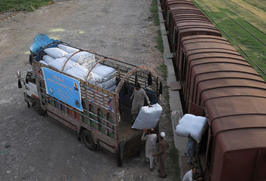 Workers load sacks of relief goods for flood victims in Balochistan on August 5.