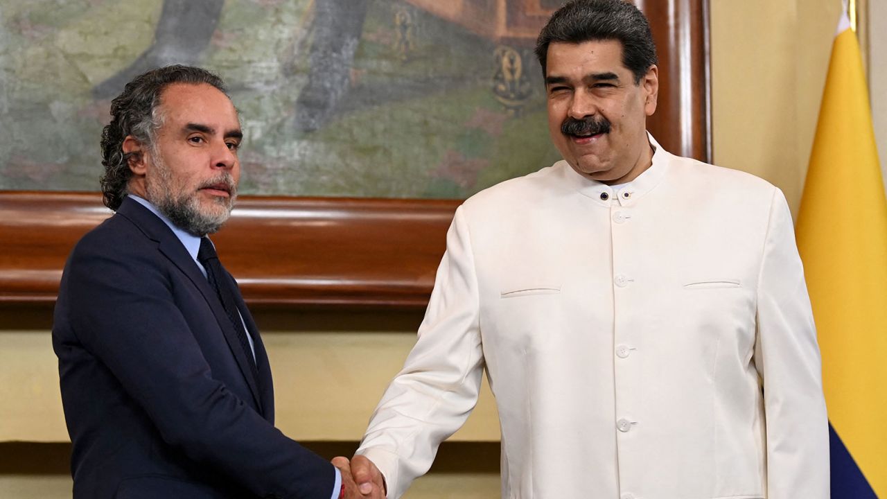 The new Colombian ambassador to Venezuela, Armando Benedetti (L) shakes hands with Venezuelan President Nicolas Maduro after presenting his credentials.