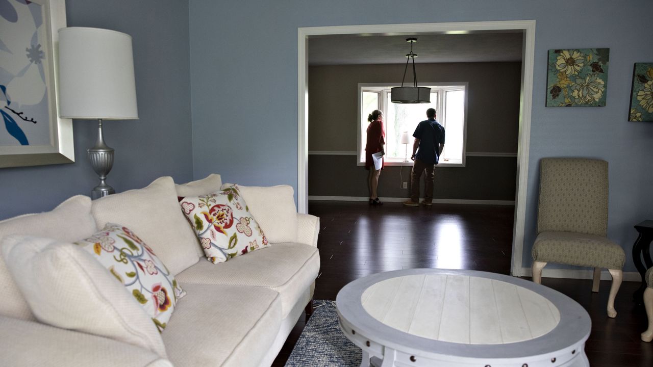 A real estate agent shows a prospective home buyer a house for sale in Peoria, Illinois, on May 30, 2019. 