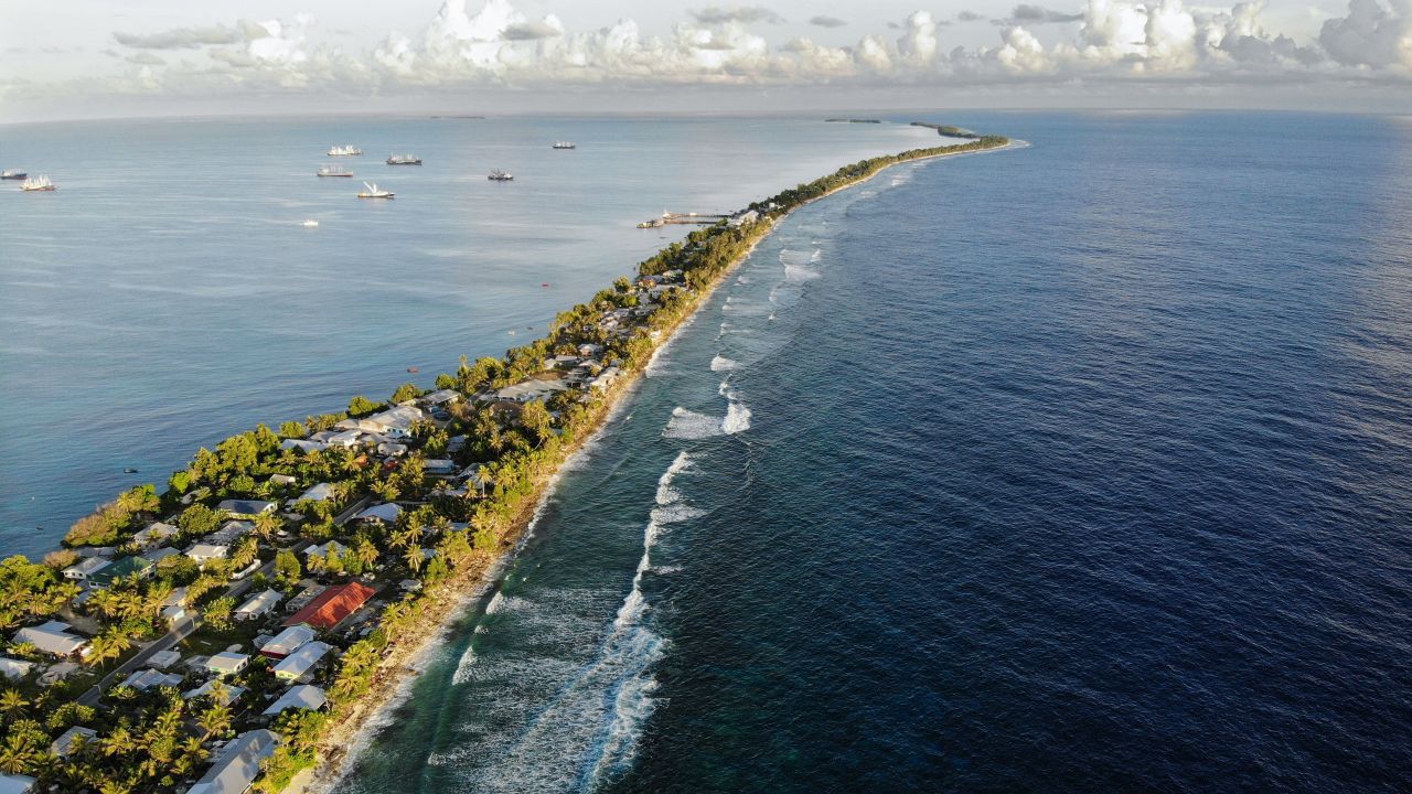 FUNAFUTI, TUVALU - NOVEMBER 28: An aerial view of a strip of land between the Pacific Ocean (R) and lagoon on November 28, 2019 in Funafuti, Tuvalu. The low-lying South Pacific island nation of about 11,000 people has been classified as 'extremely vulnerable' to climate change by the United Nations Development Programme. The world's fourth-smallest country is struggling to cope with climate change related impacts including five millimeter per year sea level rise (above the global average), tidal and wave driven flooding, storm surges, rising temperatures, saltwater intrusion and coastal erosion on its nine coral atolls and islands, the highest of which rises about 15 feet above sea level. In addition, the severity of cyclones and droughts in the Pacific Island region are forecast to increase due to global warming. Some scientists have predicted that Tuvalu could become inundated and uninhabitable in 50 to 100 years or less if sea level rise continues. The country is working toward a goal of 100 percent renewable power generation by 2025 in an effort to curb pollution and set an example for larger nations. Tuvalu is also exploring a plan to build an artificial island.   (Photo by Mario Tama/Getty Images)