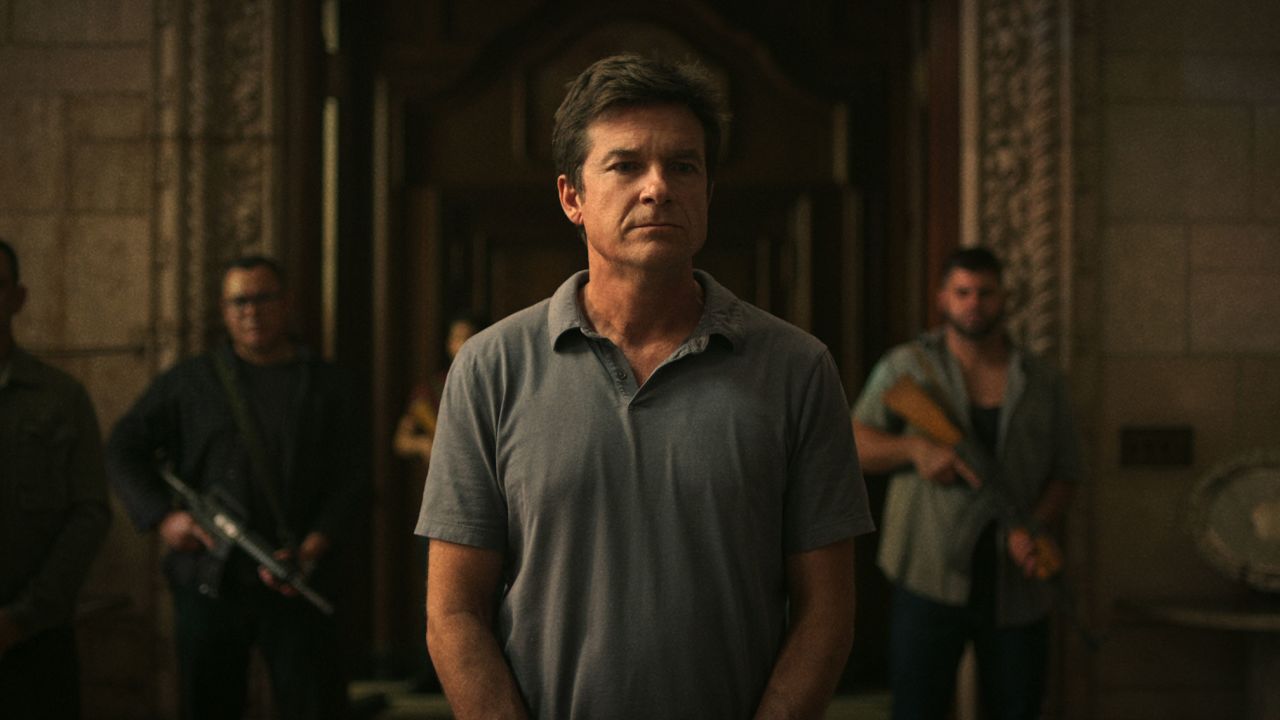Marty Byrde (Jason Bateman) stands flanked by armed guards at the home of drug lord Omar Navarro on "Ozark."