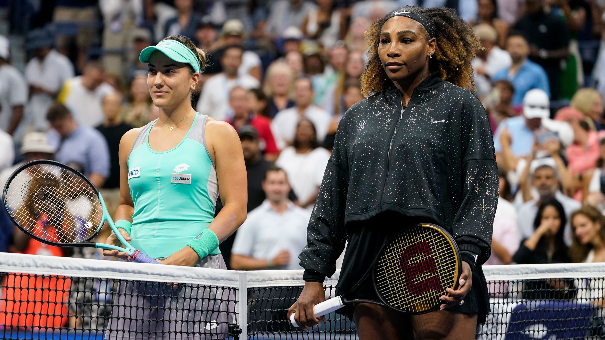 Williams and Kovinic pose for photos before playing Monday. Kovinic, a 27-year-old from Montenegro, is ranked 80th in the world.