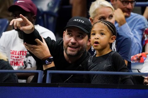 Williams' husband, Alexis Ohanian, watches Monday's match with their daughter, Olympia.