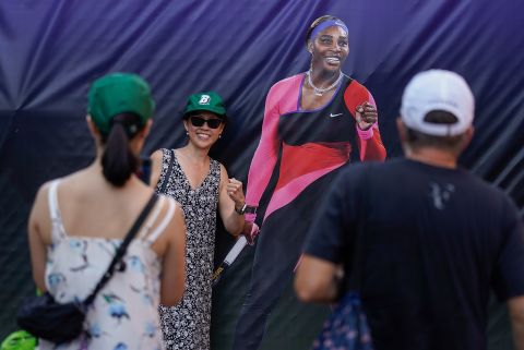 Fans airs  for photos adjacent  to a life-sized representation  of Williams connected  Monday.