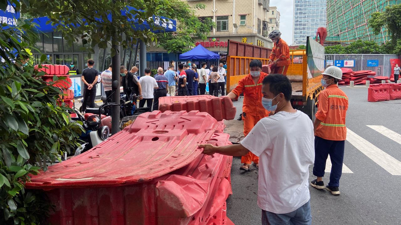 Workers set up barricades outside an entrance to Wanxia urban village as part of Covid-19 control measures in Shenzhen, Guangdong province, China on August 29, 2022.