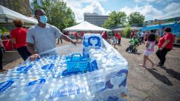 Michael Roche, left, with the Mississippi Food Network, waits for the next person for water distribution during a Safe Water Rally hosted by the Jackson Association of Educators and the Mississippi Association of Educators in Jackson, Miss., Saturday, Aug. 27, 2022. 
