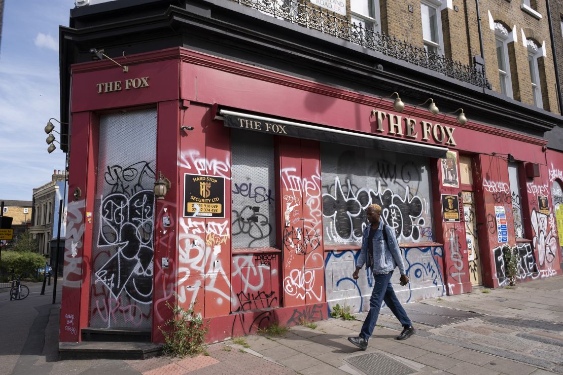 Graffiti covers a closed-down pub in London.