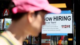 A "Now Hiring" sign is displayed on a shopfront on August 5, 2022 in New York City. 