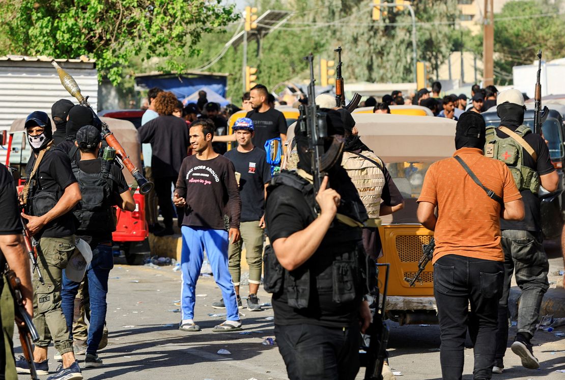 Fighters loyal to al-Sadr gather during clashes with Iraqi security forces near Baghdad's Green Zone on Monday.