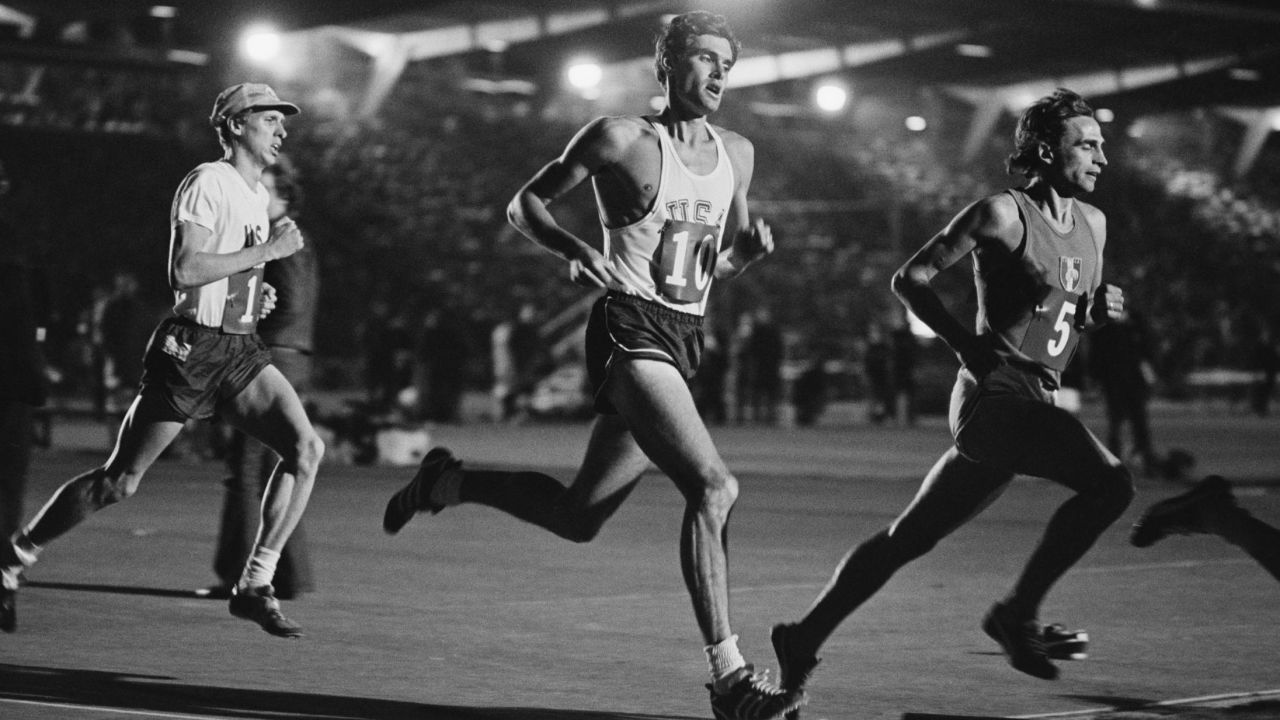 Wottle (left) races behind the US' Jim Ryun (center) at Crystal Palace in London.