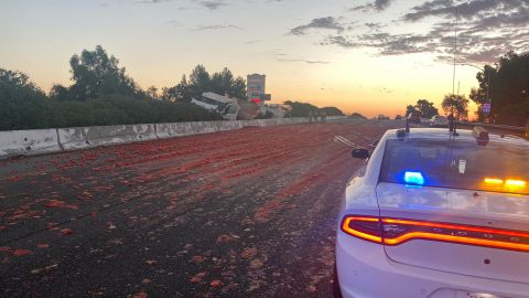 Transportation staff worked for hours to clear thousands of tomatoes off the highway after a truck crashed Monday in California.