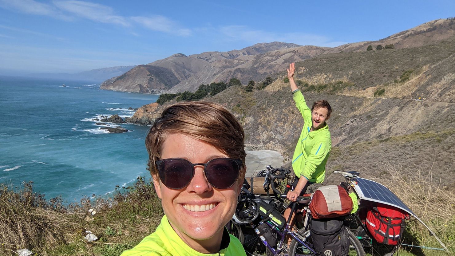 Will and Claire Stedden, posing in Big Sur, with their bikes.