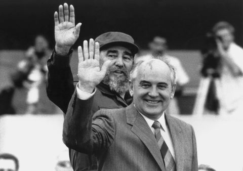 Gorbachev and Cuban President Fidel Castro wave during Gorbachev's visit to Cuba in April 1989.