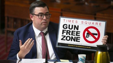 Robert Barrows, the head of NYPD's legal operations, holds a temporary Gun Free Zone sign during a New York City Council Committee on Public Safety hearing.