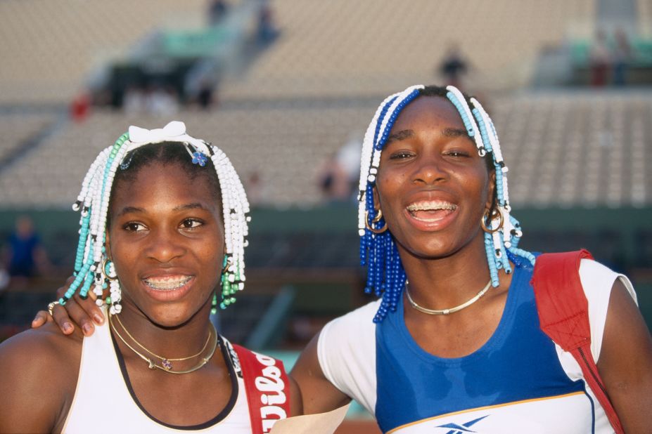In the late 1990s, Serena and Venus Williams turned heads in their matching beaded braid hairstyles. The embellished cornrows were often challenged by rule makers, but the beads (as pictured here at the 1998 Roland Garros French Open) sent an important message to Black women everywhere. 