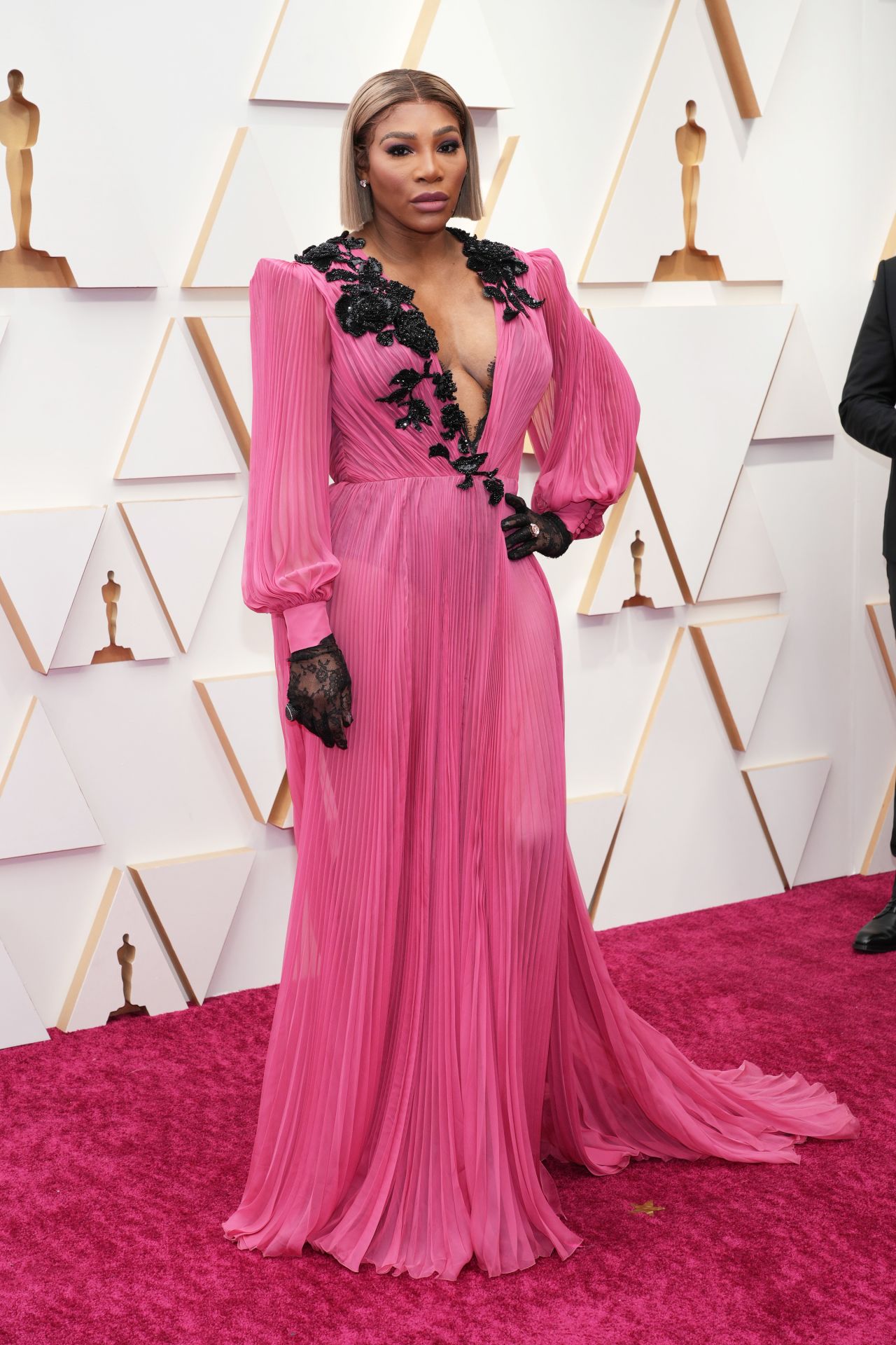At the 2022 Oscars, Williams arrived in an accordion-style Gucci gown with lace detailing accentuating a plunging neckline.