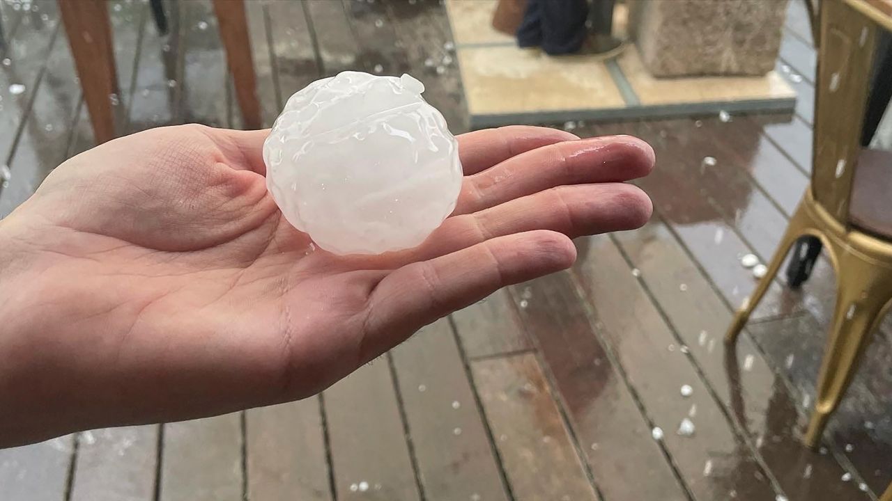 A person holds up a hailstone during a hailstorm in Girona, Spain, on Tuesday.