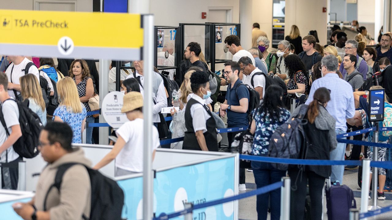 NEWARK, NJ - JULY 01: Travelers line up to enter a security checkpoint at Newark Liberty International Airport (EWR) on July 1, 2022 in Newark, New Jersey. Hundreds of flights were canceled across the US ahead of July Fourth weekend. 