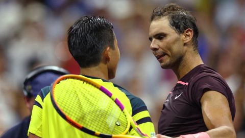 Nadal (right) and Hijikata meet at the net after the first round match. 