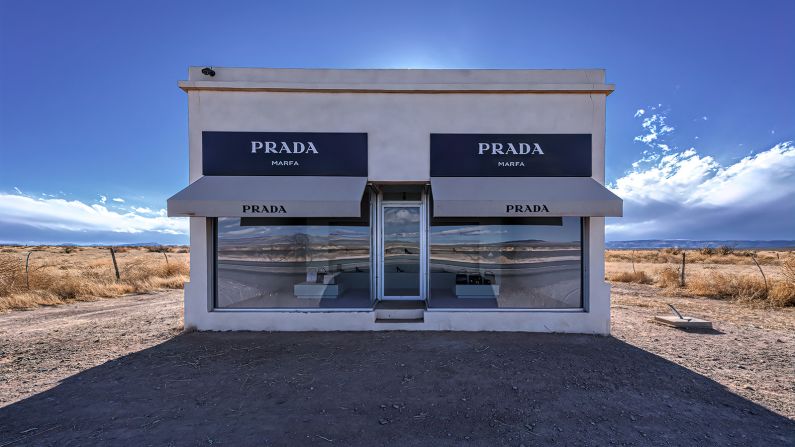 Bright sunshine behind the front of the Prada store art installation along the highway to Marfa, Texas.  Prada Marfa is a permanently installed sculpture and art installation by artists Elmgreen and Dragset and resembles a Prada store in Marfa, Texas. It is located in the desert about forty miles from Marfa which is located in West Texas.