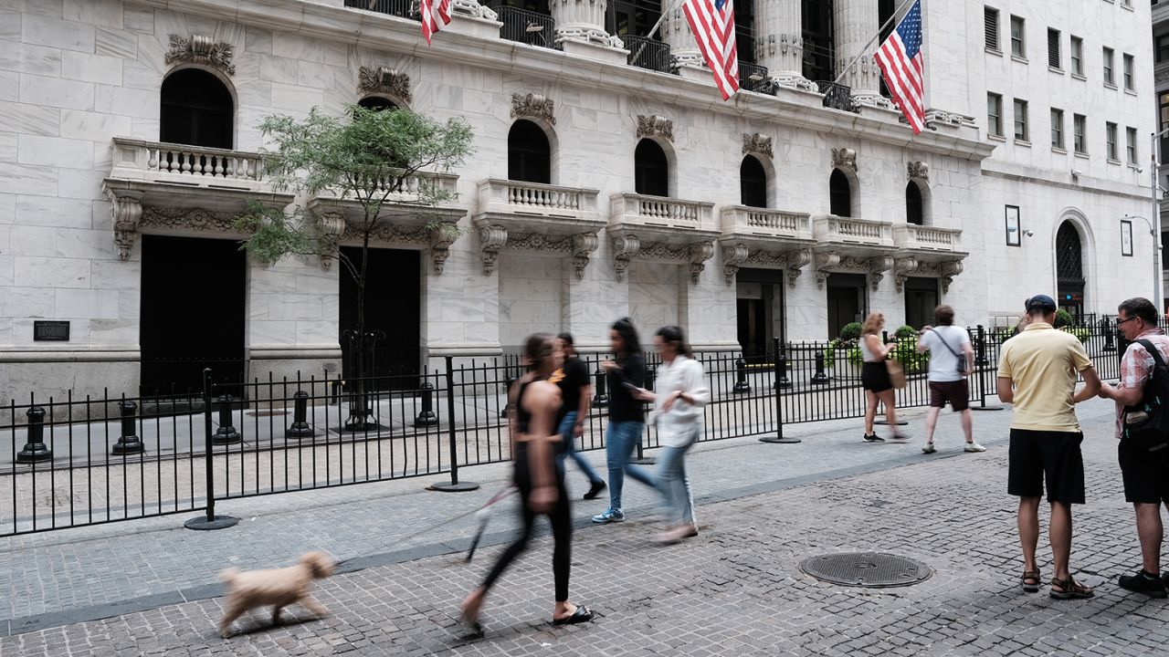 Pedestrians walking by the New York Stock Exchange on August 26. Five state-owned Chinese companies moved to delist from the exchange earlier this month. 