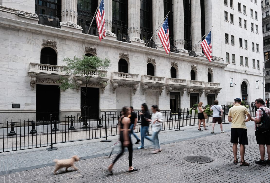 Pedestrians walking by the New York Stock Exchange on August 26. Five state-owned Chinese companies moved to delist from the exchange earlier this month. 