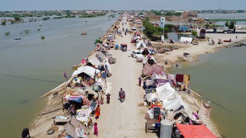 People in Pakistan take refuge from flooding in a makeshift camp on August 31 in the Jaffarabad district of Balochistan province.