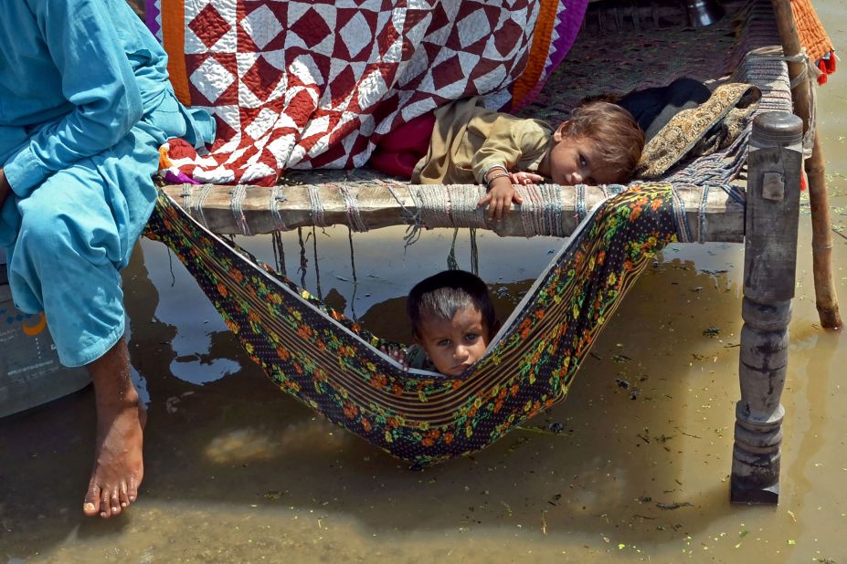 Children sit on a charpai in the Jaffarabad district on August 31.