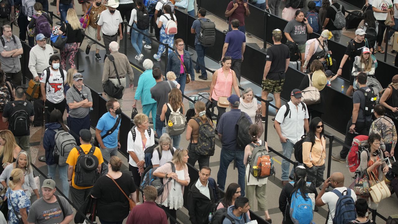 Travelers queue up at the south security checkpoint in Denver International Airport as the Labor Day holiday approaches,on Tuesday, August. 30, 2022.