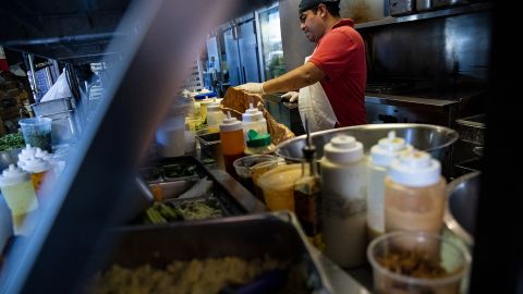 A restaurant worker prepares a sauce at a tavern in Washington, D.C.