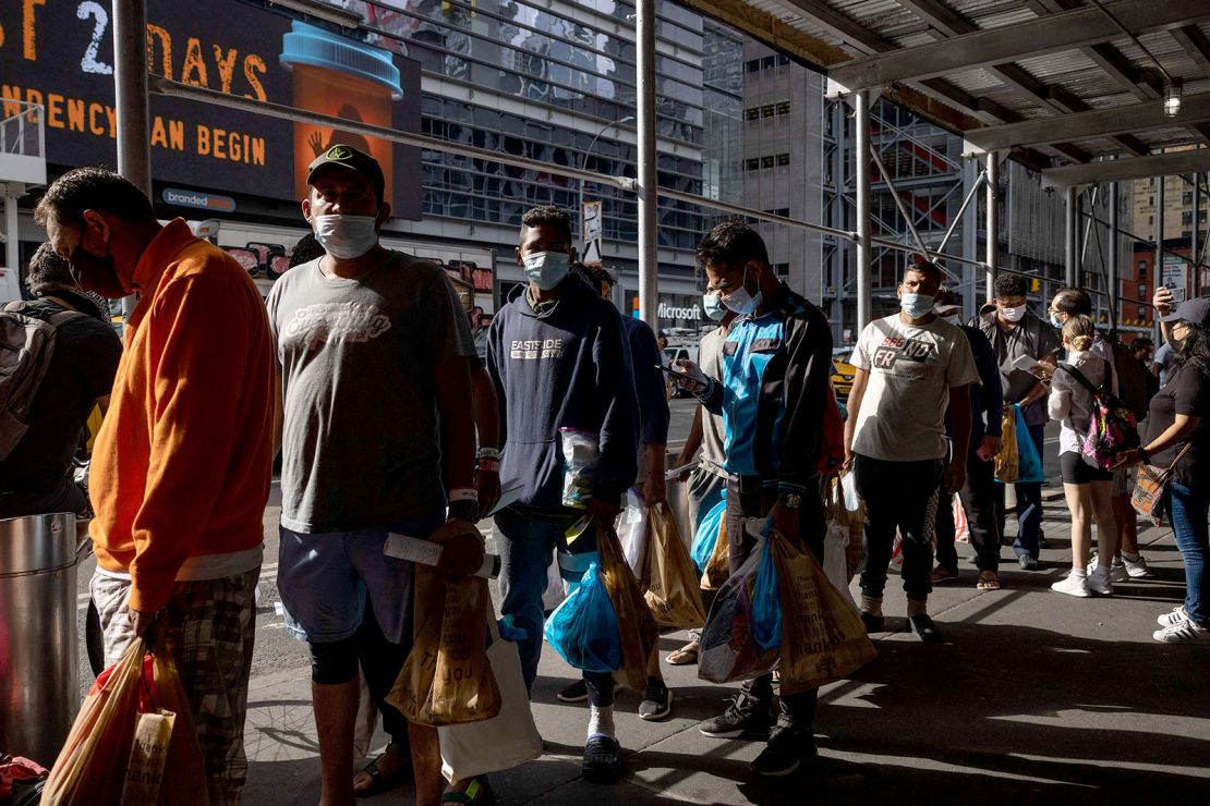 Migrants wait in line last month outside the Port Authority after arriving from Texas.