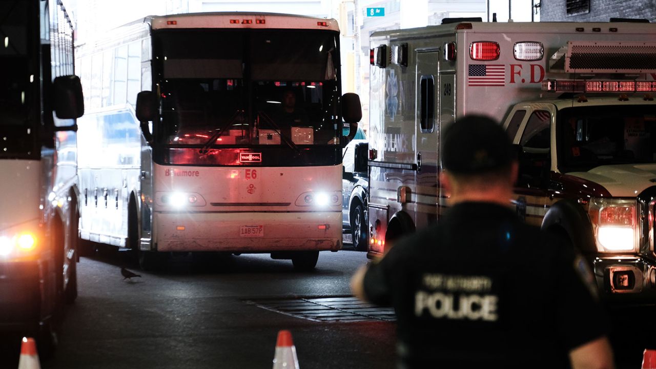 A bus carrying migrants who crossed the border from Mexico into Texas arrives at the Port Authority bus station in Manhattan on August 25.