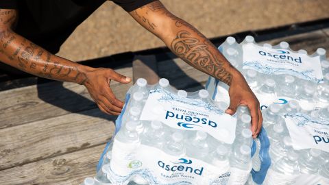 Malcolm Pickett lifts a case of water outside of New Jerusalem Church in Jackson, Mississippi, on August 31.