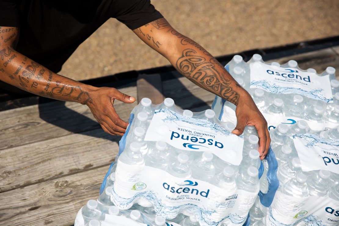 Malcolm Pickett lifts a case of water outside of New Jerusalem Church in Jackson, Mississippi, on August 31.