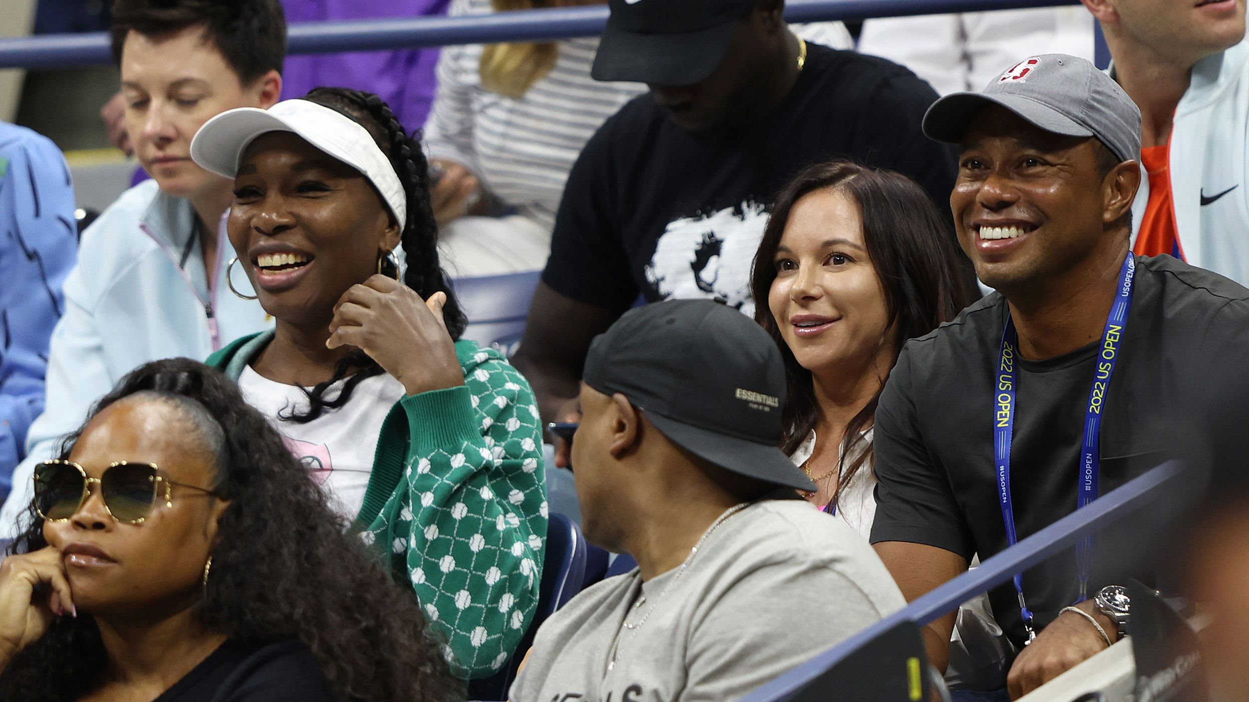 Williams' sister Venus, left, watches Wednesday's match near Woods and his partner, Erica Herman.