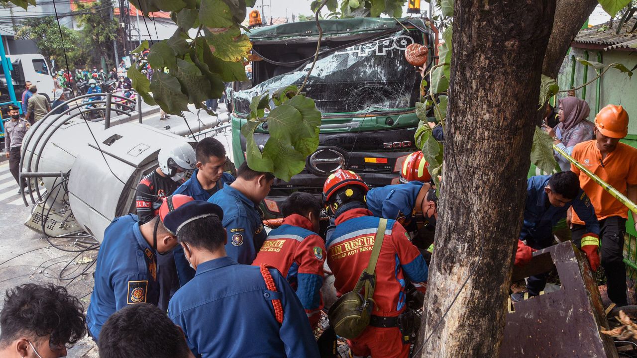 Rescuers at the site of the crash in Bekasi, Indonesia.