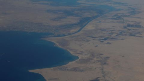 An aerial view of the Gulf of Suez and the Suez Canal pictured through an airplane window.