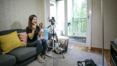Park Su-hyang, a North Korean defector, records a YouTube video at home in Seoul, South Korea on May 19, 2018. 