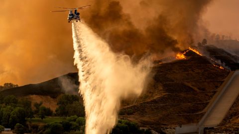 Helicopters drop water on the Route Fire in Castaic, California, Wednesday.