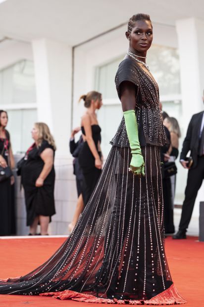 At the same premiere, actor Jodie Turner-Smith stepped out in a black sheer Gucci number accessorized with lime green evening gloves.