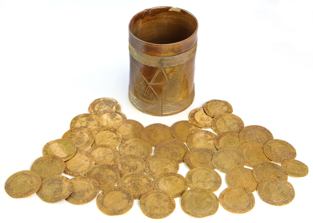 The discovery of more than 260 gold coins dating back to the 17th and 18th centuries is "one of the largest on archaeological record from Britain," according to auctioneers Spink & Son.