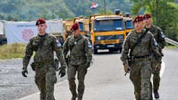 Polish soldiers, part of a NATO peacekeeping mission in Kosovo pass through barricades near the border crossing between Kosovo and Serbia in Jarinje, Kosovo, September 28, 2021.
