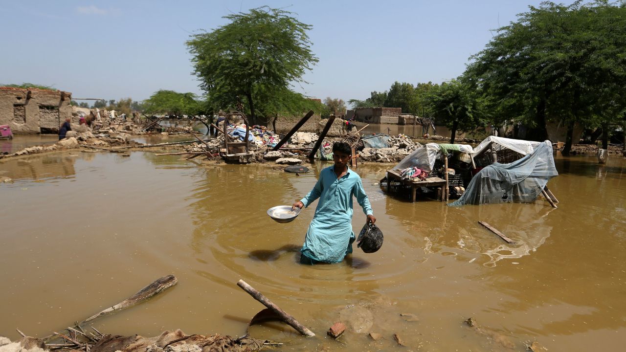 A man looks for salvageable belongings from his flooded home in the Shikarpur district of Sindh Province, Pakistan on Thursday.